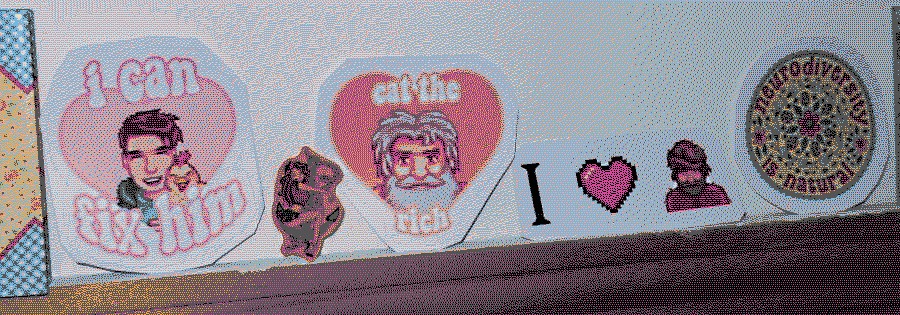 A row of stickers lined up against a wall. From left to right, a sticker of Shane from Stardew Valley smiling and holding a chicken with the caption 'I can fix him,' a sticker of a cute wavy-haired cartoon girl in a mini skirt wrapping herself around an anchor, a sticker of Linus from Stardew Valley captioned 'Eat the rich,' a sticker featuring Willie from Stardew Valley, and a sticker with intricate floral details and ladybugs that says 'Neurodiversity is natural'