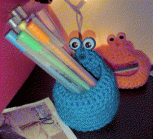 A blue yip-yip holding colorful pens in its mouth. The orange yip-yip is behind it.