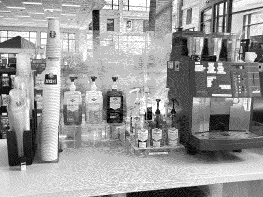 A barista work station, featuring various flavored sauces and syrups, and an espresso machine