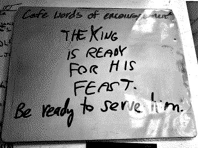 A whiteboard that says 'Café words of encouragement.' Underneath, I wrote 'The King is ready for his feast. Be ready to serve him.