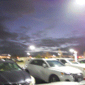 A blurry photo of cars in a parking lot